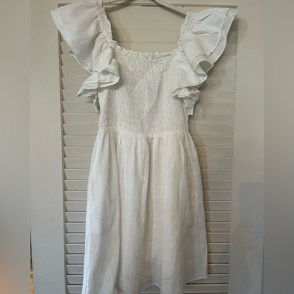 Flutter sleeve, smocked dress with pockets.